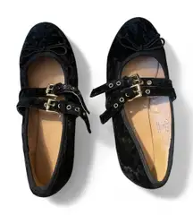 Black velvet flats with a gold buckle