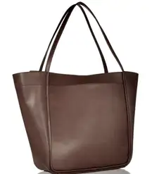 Brown leather Calvin Klein tote bag with adjustable straps, featuring a spacious interior with pockets and a magnetic snap closure. #leatherbag #totebag #calvinKlein #brownleather #fall 