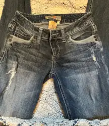 YMI women's low-rise dark wash with white stitching and a size 0 tag