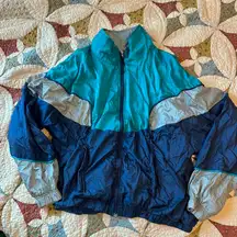 Blue, navy, and gray vintage 80s nylon windbreaker jacket. Size L.