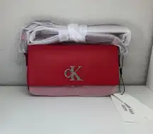 New Red CK monogram logo design Top flap closure Shoulder strap 51% recycled post-consumer polyester 49% polyurethane Imported 7.2" wide x 3.9" tall x 1.6" deep Style #: 37300625