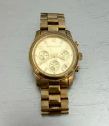 Michael Kors gold watch. Slightly tarnished, good condition. Needs new battery.