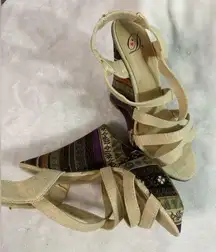 Beige platform heels with crossed strap details.