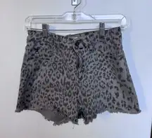 These KanCan jean shorts feature a chic gray color with a stylish leopard print design, offering a trendy and comfortable fit. The elastic waistband ensures ease of wear, while the soft fabric provides all-day comfort. Perfect for adding a touch of wild elegance to your casual wardrobe.