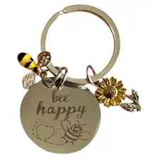 Cute cheerful keychain with 'bee happy' inscription. Also has a charming bee & a flower charm. Perfect for adding a touch of joy to your keys or bag. No returns.