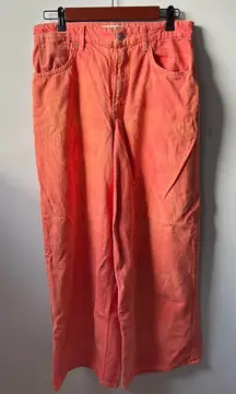 Vintage-style We The Free wide-leg pants in a faded coral/pink wash.