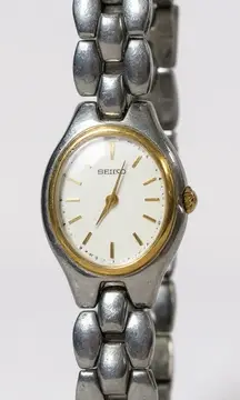 Seiko Oval Women's Two Tone Silver and Gold Wrist Sunburst Dial Watch 1N00-6F80
