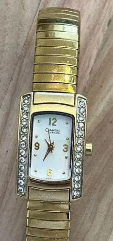 Caravelle by Bulova Ladies Watch Crystals White Dial Gold Tone Stretch Bracelet