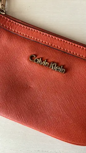 Calvin Klein leather orange wristlet with gold hardware