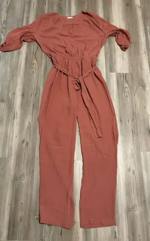 Maronie Jumpsuit Size Large, with tie belt and front chest closure,Mauve, Pit to pit is 22, length from shoulder to foot is 54, stretch waist, adjustable sleeve - Image 1