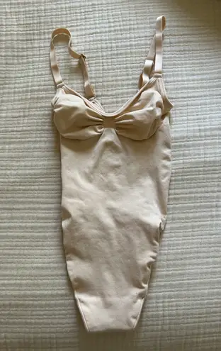SKIMS Seamless Sculpt Thong Bodysuit in “Sand”