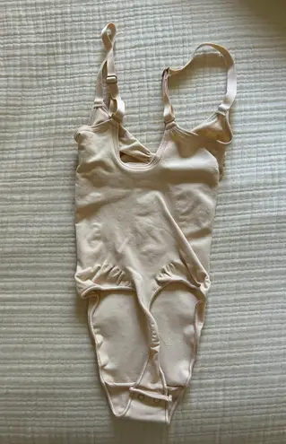 SKIMS Seamless Sculpt Thong Bodysuit in “Sand”