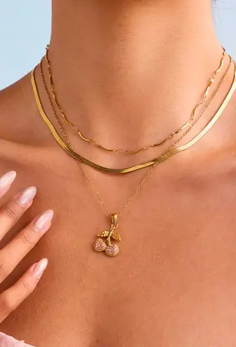 Cherry charm on a gold necklace
