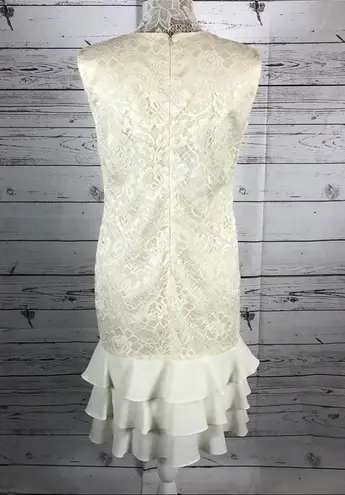 Leslie Fay  sleeveless 
Beautiful lace dress with layered ruffles on the end.