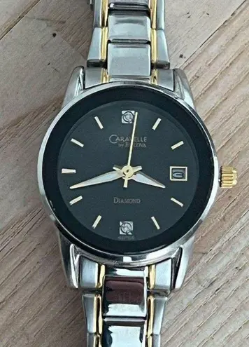 Caravelle by Bulova Ladies Watch Diamonds Black Dial Two Tone Bracelet
