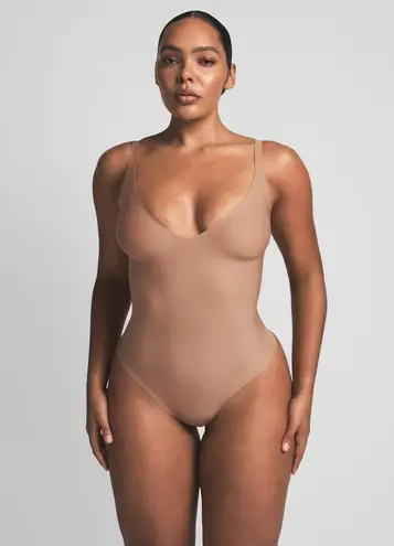 SKIMS Body Unlined Plunge Thong Bodysuit in Sienna, Size Small