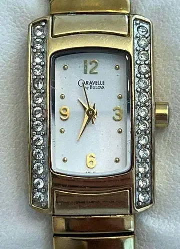 Caravelle by Bulova Ladies Watch Crystals White Dial Gold Tone Stretch Bracelet