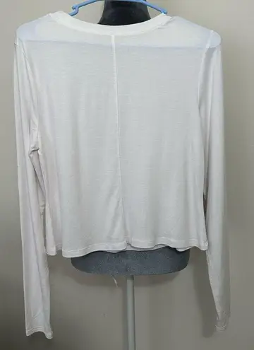 Apana M EUC white long sleeved athletic shirt.