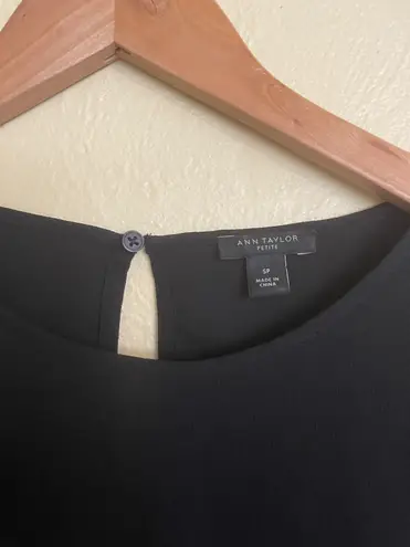 Ann Taylor black tie-sleeve blouse -SP  Gently used and in very good condition other than one tiny snag on left sleeve as circled. Size petite small.  black polyester blouse with bow tie sleeves. $80 retail.