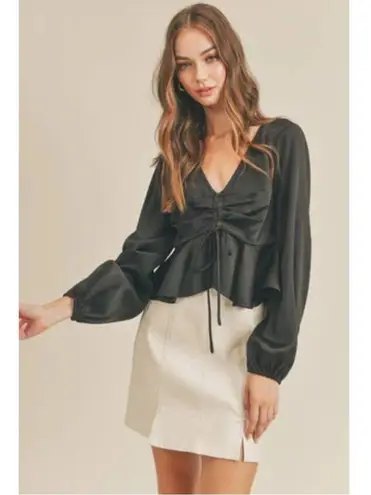 All in Favor black " Tie Front Satin Peplum Top" with a V-neck and long sleeves.