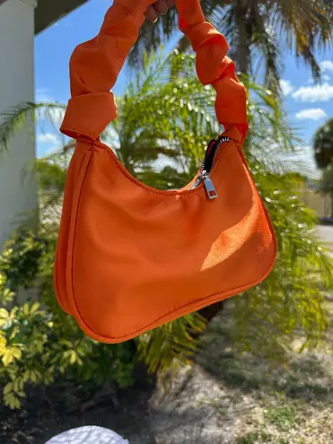 Vibrant Orange Crescent Shoulder Bag with Compact Design