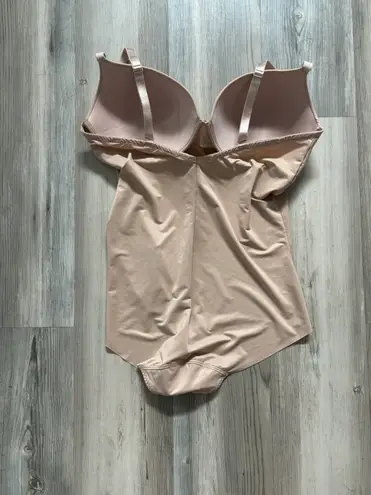 Spanx Assets Size Large, nude in color, built in convertible bra adjustable straps, pit to pit is 5, length from top to bottom is 19