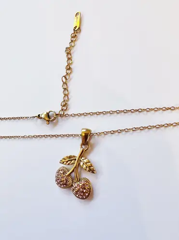 Cherry charm on a gold necklace