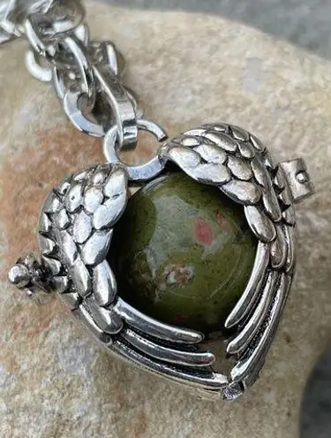Unakite confidence gemstone in a heart shaped necklace cage. 36” chain
