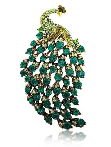 Brooch peacock in sparkly emerald green crystals in a gold and black pin