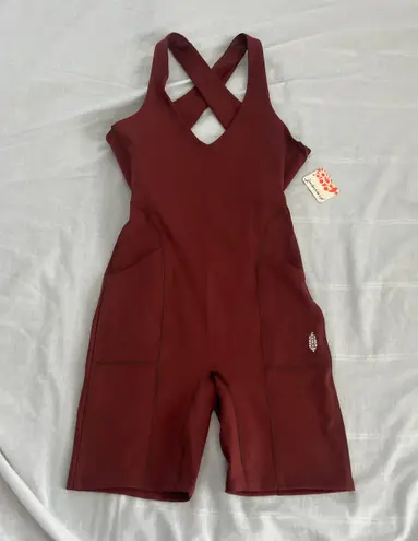 Free People Movement Here On Out Strappy Onesie Romper   Size XS  Condition: NWT  Color: nutmeg  Details : - See photo for approx. inseam measurement laying flat  - Built-in bra - not padded - Side pockets.