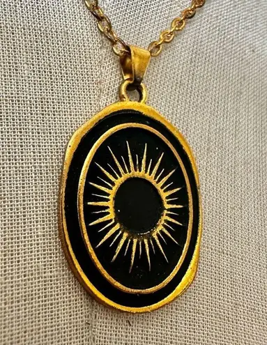 Like calls to Like gold tone and black starburst pendant necklace