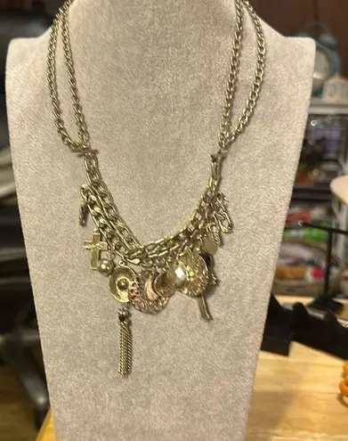 Very cute charm necklace. It has a cross with black in the middle.