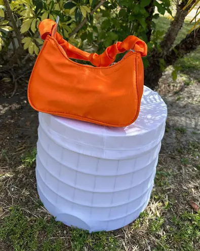 Vibrant Orange Crescent Shoulder Bag with Compact Design