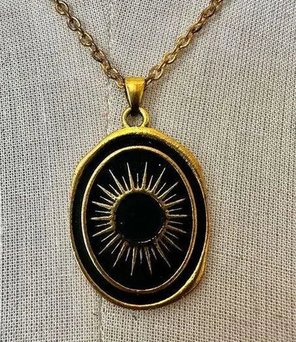 Like calls to Like gold tone and black starburst pendant necklace
