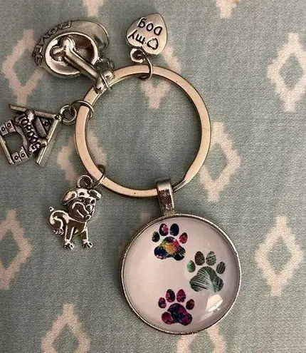 Puppy Keychain NWOT. Paw prints, dog house, dog, name tag and food dish charms.