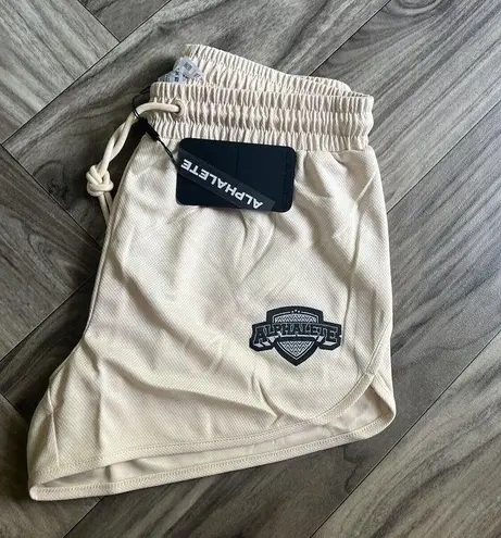 Alphalete NEW  Woman’s Varsity Short - Tan ,size XS