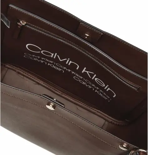 Brown leather  tote bag with adjustable straps, featuring a spacious interior with pockets and a magnetic snap closure. #leatherbag #totebag #calvinKlein #brownleather #fall  - Image 3