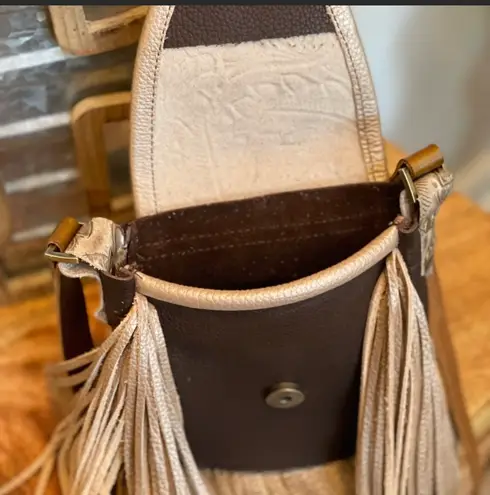 Deep brown and golden browns are stunning on this leather crossbody purse.