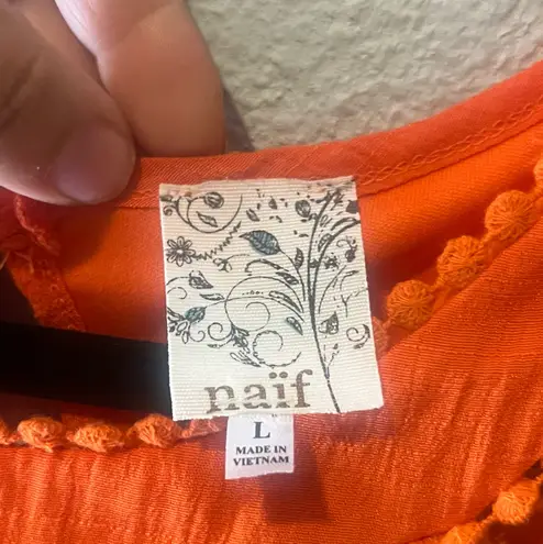 Naïf Bright Orange Sleeveless Dress – Made in Vietnam Flowy and fresh sleeveless dress in a vibrant orange tone.