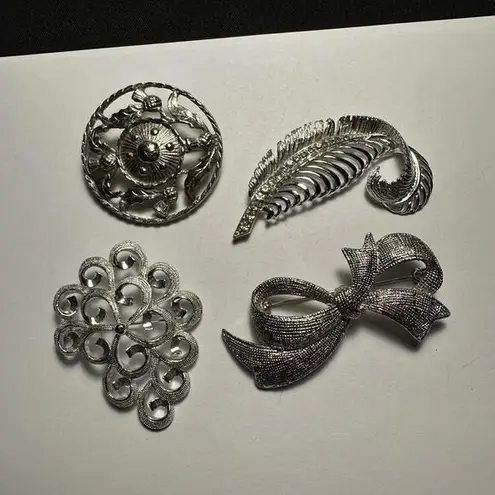 Lot Of 4 Silver Tone Brooch Pins Feather With Rhinestones, Bow, Swirls, Round