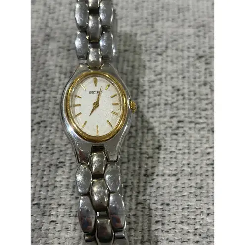 Seiko Oval Women's Two Tone Silver and Gold Wrist Sunburst Dial Watch 1N00-6F80