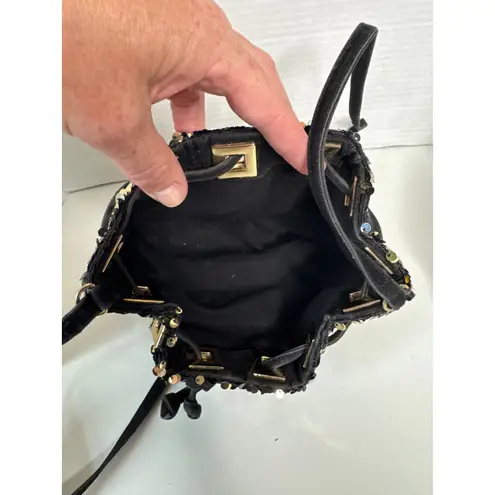 Retro style Sequin bucket bag in black and gold with pull closing inside lined