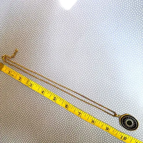 Like calls to Like gold tone and black starburst pendant necklace