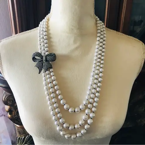 R.J. Graziano triple strand graduated white pearl stone bow necklace
