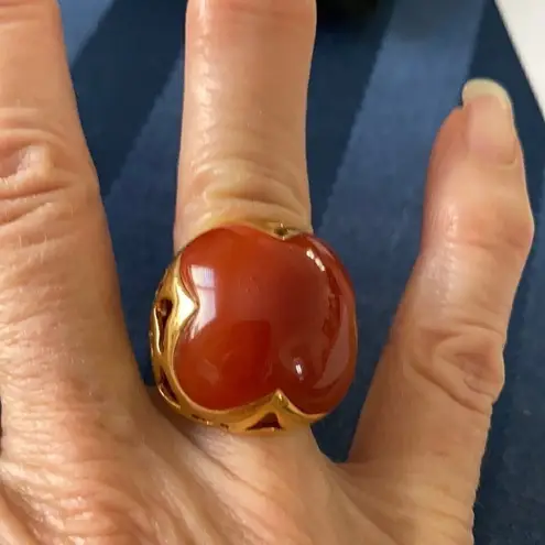 Very ornate gold colored ring with a large orangish center stone size 5 EUC