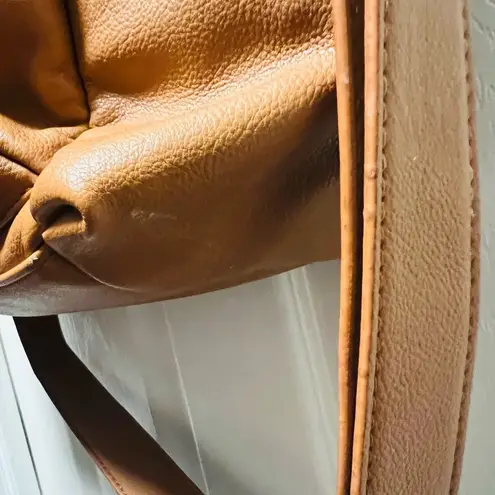 Brown patent leather diaper bag with multiple pockets and key holders