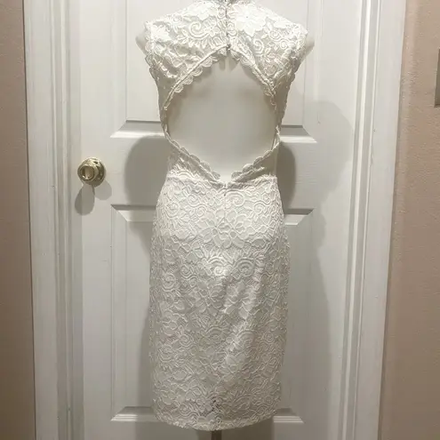 Mystic White lace dress with open back.