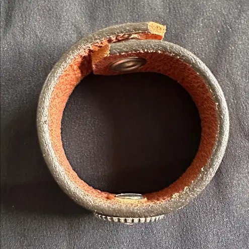 Leather EUC snap bracelet with silvertone medallion and CZ center stone Brown