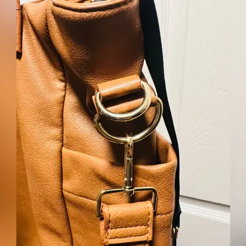 Brown patent leather diaper bag with multiple pockets and key holders