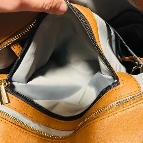 Brown patent leather diaper bag with multiple pockets and key holders